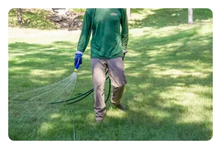 tech spraying on lawn